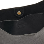 Close-up of Il Bisonte Nero crossbody bag showing smooth full-grain texture and Tuscan craftsmanship.