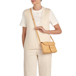 Model wearing the Il Bisonte Linea 1990 crossbody bag in natural styled with timeless everyday essentials