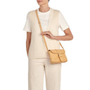 Model wearing the Il Bisonte Linea 1990 crossbody bag in natural styled with timeless everyday essentials