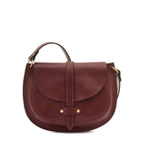 Side detail of the Il Bisonte Archivo Saddle Bag in Black Cherry showing magnetic closure, strap detail, and rich leather texture.