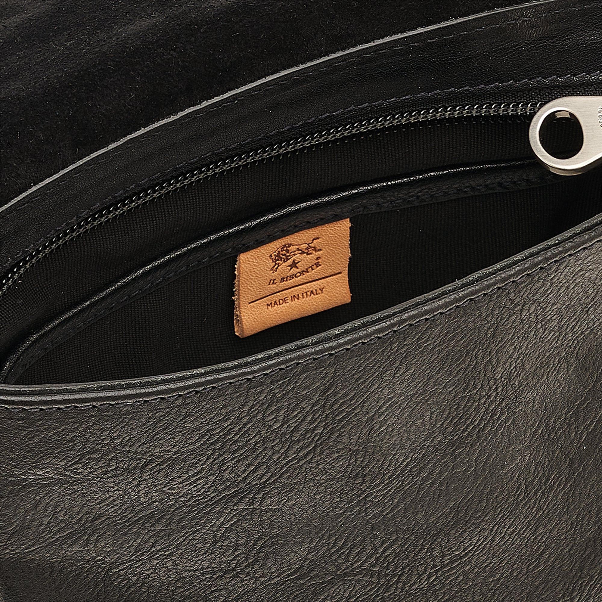 Close-up detail of the Brolio Men’s Crossbody in Black highlighting nickel hardware, stitching, and full-grain leather texture.