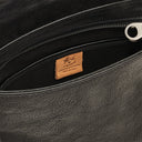Close-up detail of the Brolio Men’s Crossbody in Black highlighting nickel hardware, stitching, and full-grain leather texture.