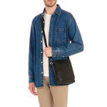 Side angle of the Il Bisonte Brolio Bag in Black showing the rounded flap design, adjustable buckle strap, and smooth Italian leather finish.