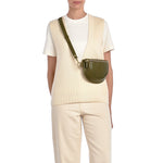 Side angle of the Oliveta Fanny Pack in Verde showing the zipper opening, strap detail, and rich Italian leather finish.