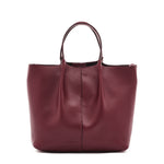 Maroon leather tote bag on a white background