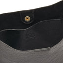 Close-up of Il Bisonte Nero crossbody bag showing smooth full-grain texture and Tuscan craftsmanship.