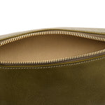 Close-up detail of the Il Bisonte Oliveta Fanny Pack in Verde highlighting the vegetable-tanned leather grain, zipper pull, and hardware.
