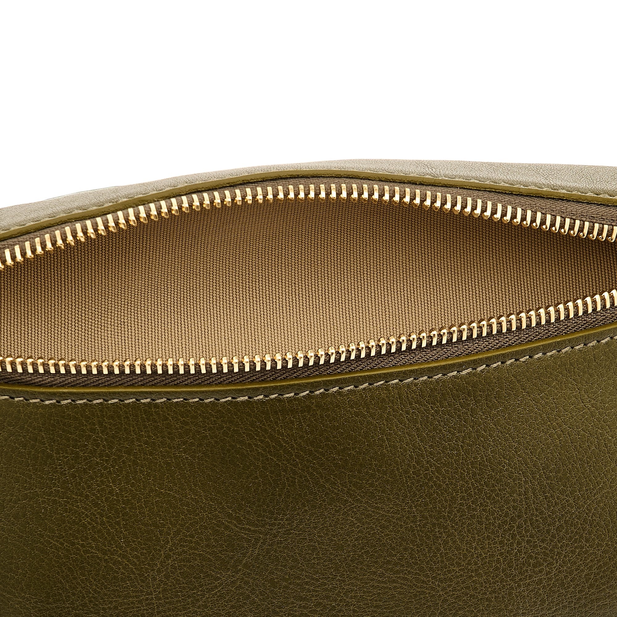 Close-up detail of the Il Bisonte Oliveta Fanny Pack in Verde highlighting the vegetable-tanned leather grain, zipper pull, and hardware.