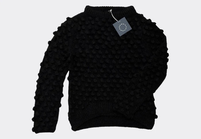 Front view of the Sphere One Buoy M5 sweater in Black, a hand-knit baby alpaca style with dramatic bobble texture and lightweight volume.