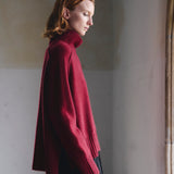 Side detail of the Sphere One Episode Sweater in Cognac Velvet showing cognac velvet patches on the lower sleeves and shoulders.