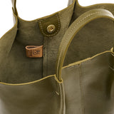 Close-up of a green leather handbag with stitching details