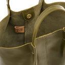 Close-up of a green leather handbag with stitching details