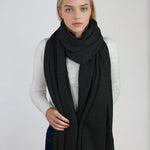 Oversized charcoal gray cashmere Scottish cashmere stole designed in Telluride and made in the USA. Ideal for travel, layering, or staying warm in style.