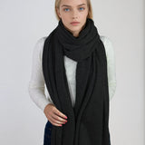 Oversized charcoal gray cashmere Scottish cashmere stole designed in Telluride and made in the USA. Ideal for travel, layering, or staying warm in style.