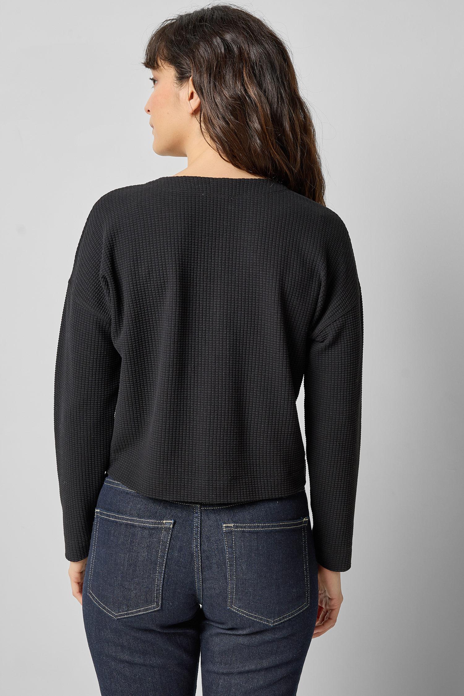 Back view of black cotton waffle knit long sleeve cropped cardigan by Lilla P.

