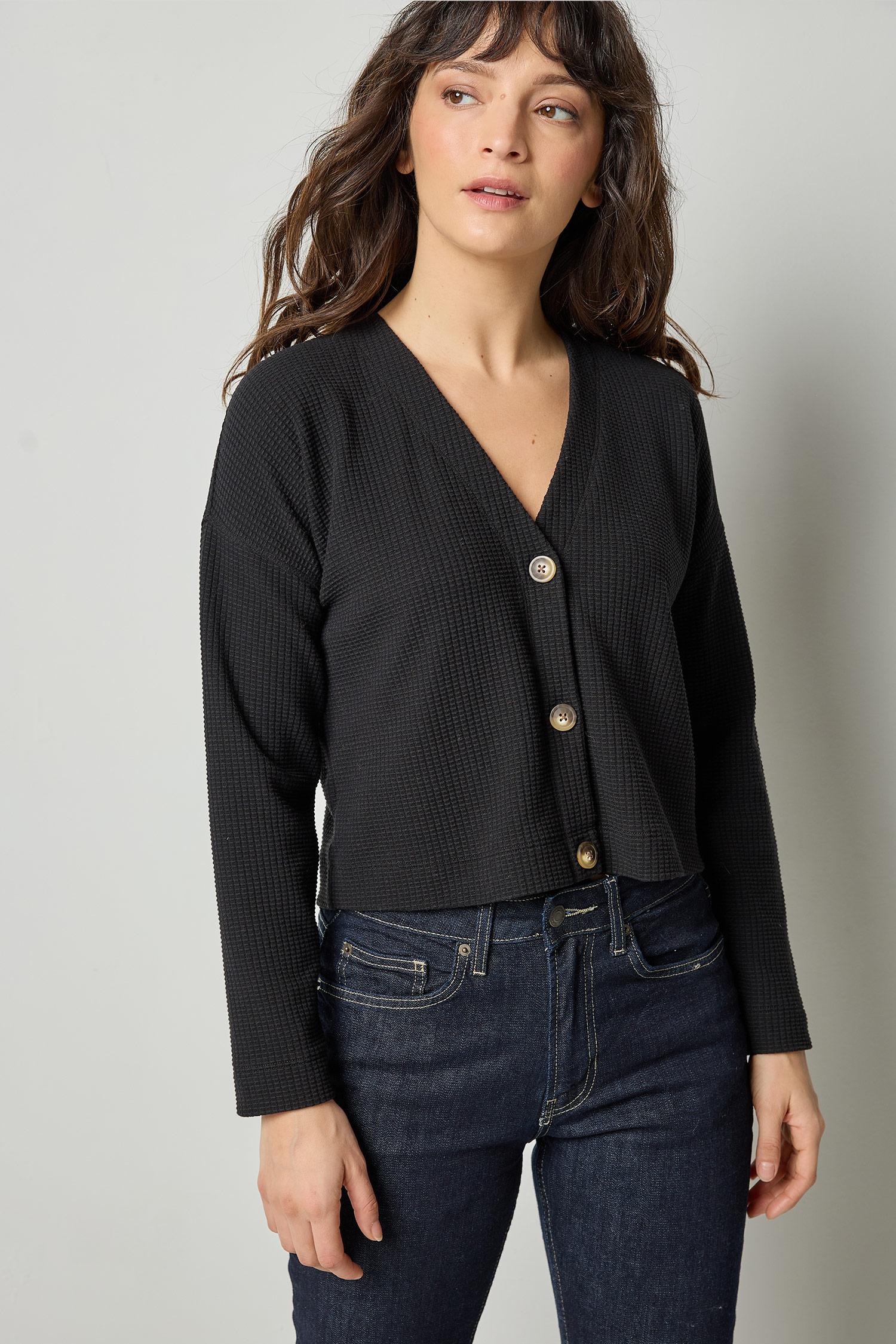 Black cotton waffle knit cardigan with long sleeves and cropped fit by Lilla P, front view.