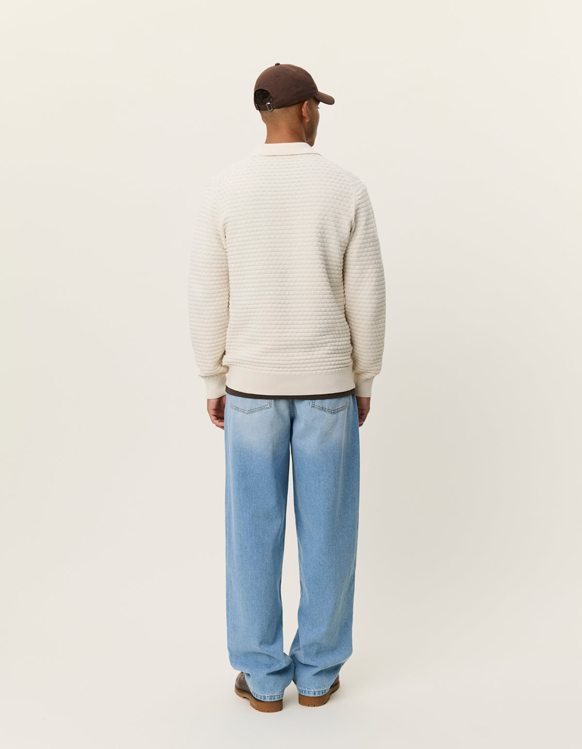 Back view of men's cotton knit polo by Les Deux with long sleeves and textured weave construction