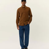 Model wearing Les Deux Konrad Corduroy Shirt in fine organic cotton corduroy, styled as lightweight everyday menswear