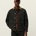 Model wearing Les Deux Layton Denim Overshirt layered over a T-shirt, casual Scandinavian menswear style