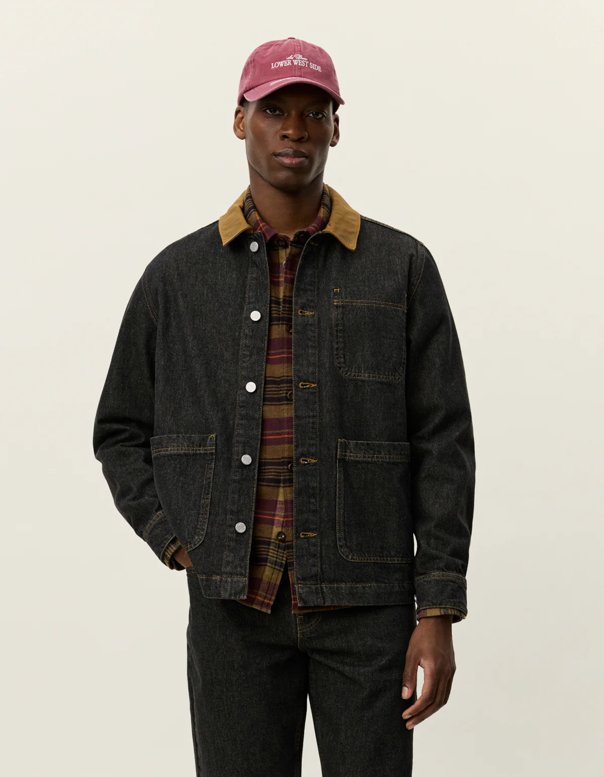 Model wearing Les Deux Layton Denim Overshirt layered over a T-shirt, casual Scandinavian menswear style