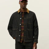 Model wearing Les Deux Layton Denim Overshirt layered over a T-shirt, casual Scandinavian menswear style