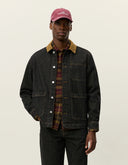 Model wearing Les Deux Layton Denim Overshirt layered over a T-shirt, casual Scandinavian menswear style