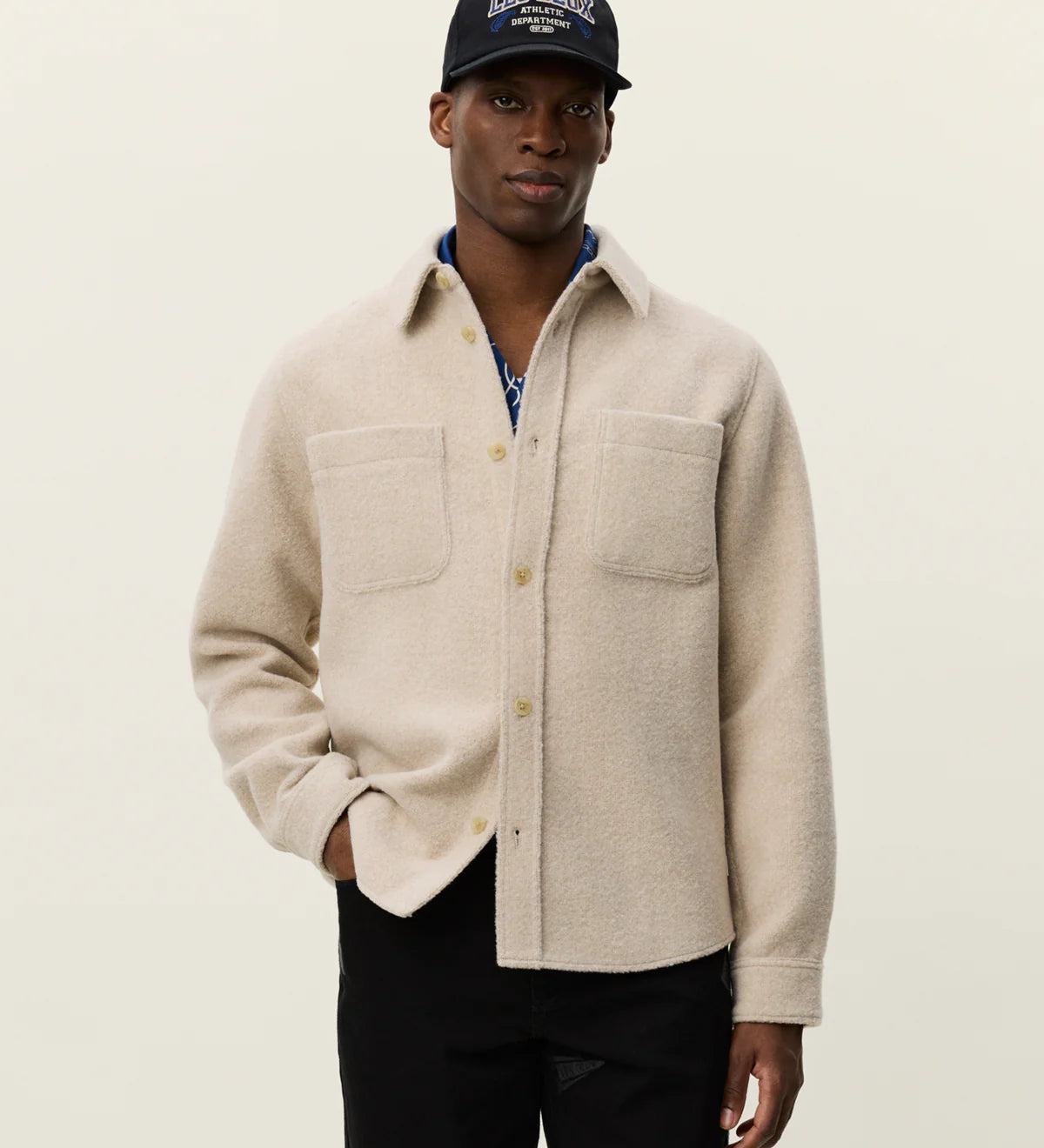 Model wearing Les Deux Lennon Bouclé Overshirt styled as a layered men’s fall look with textured Scandinavian menswear