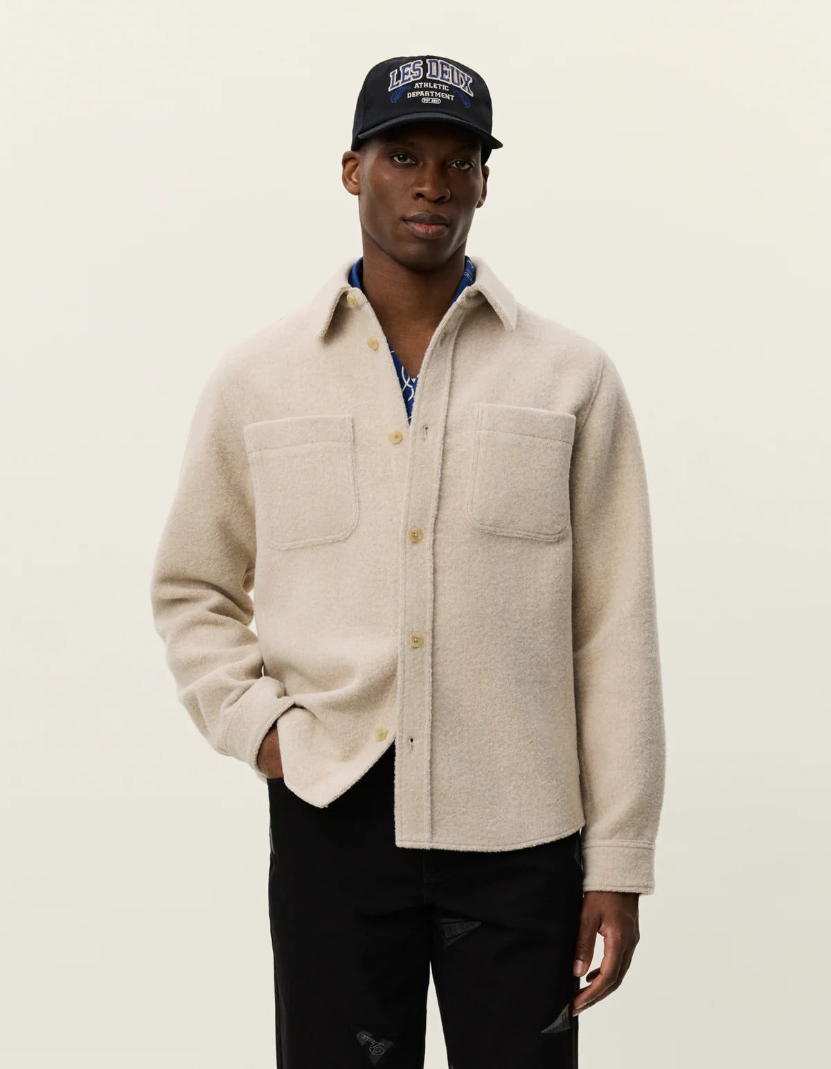 Model wearing Les Deux Lennon Bouclé Overshirt styled as a layered men’s fall look with textured Scandinavian menswear