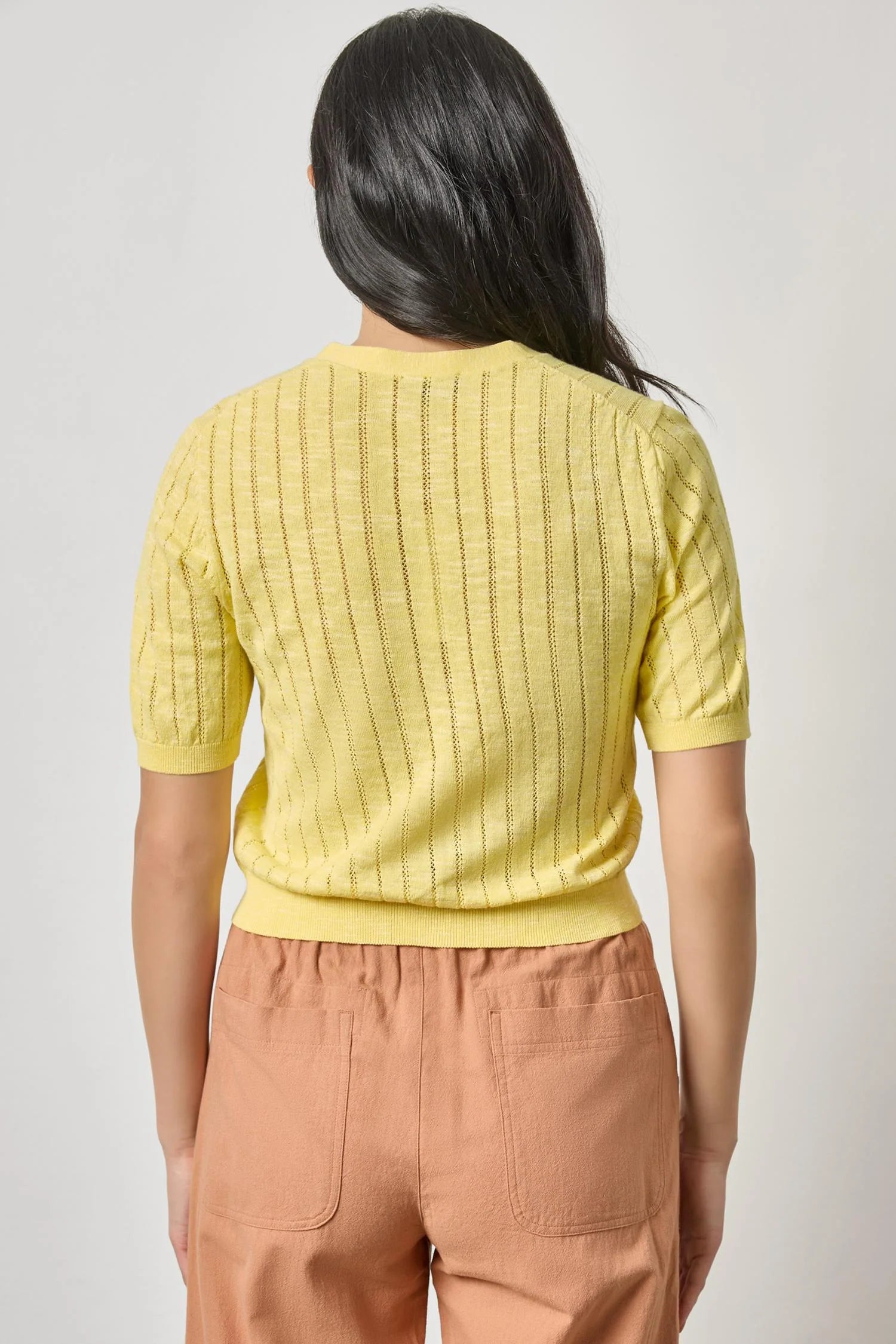 Back view of women's cotton cardigan by Lilla P in lemon with breathable knit texture