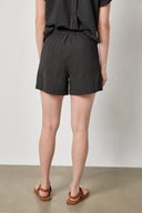 Back view of women's lightweight cotton shorts by Lilla P in black with relaxed fit