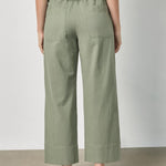 Back view of women's lightweight cotton wide leg pants by Lilla P in sage with ankle length silhouette
