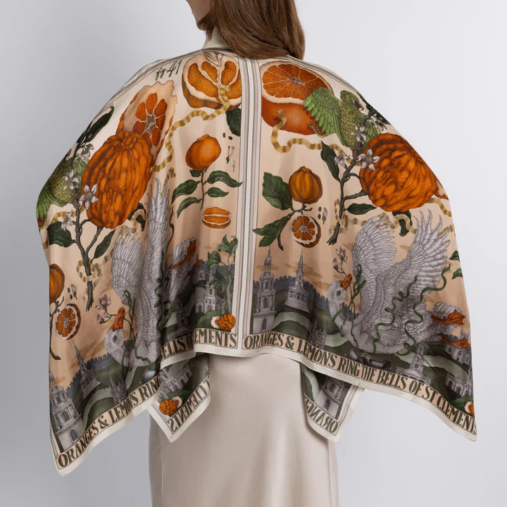 Back view of luxury silk twill blouse with illustrated oranges, lemons, and Victorian scenery

