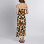 Back view of bias-cut silk slip dress with adjustable straps and vibrant botanical print

