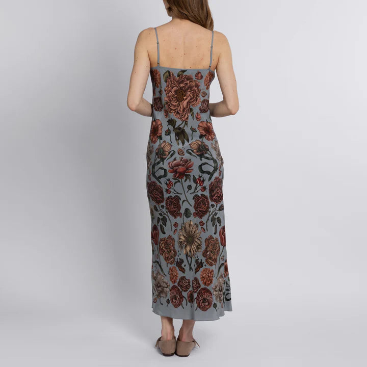 Back view of luxury silk slip dress featuring adjustable straps and floral botanical print