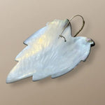 Back view of handmade gold earrings by Simon Alcantara with detailed leaf motif