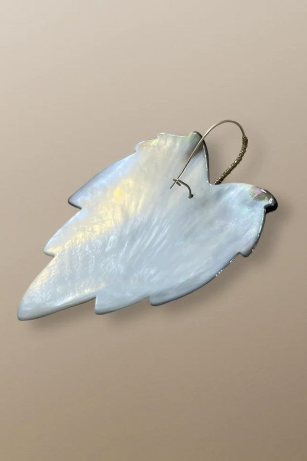 Back view of handmade gold earrings by Simon Alcantara with detailed leaf motif