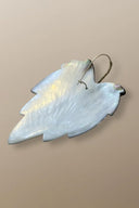 Back view of handmade gold earrings by Simon Alcantara with detailed leaf motif